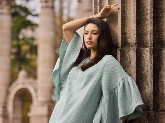Model wearing a Liz cotton gauze caftan in mint green.