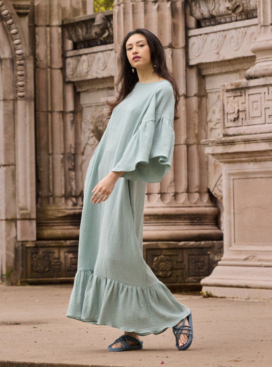 Model wearing a Liz cotton gauze caftan in mint green.