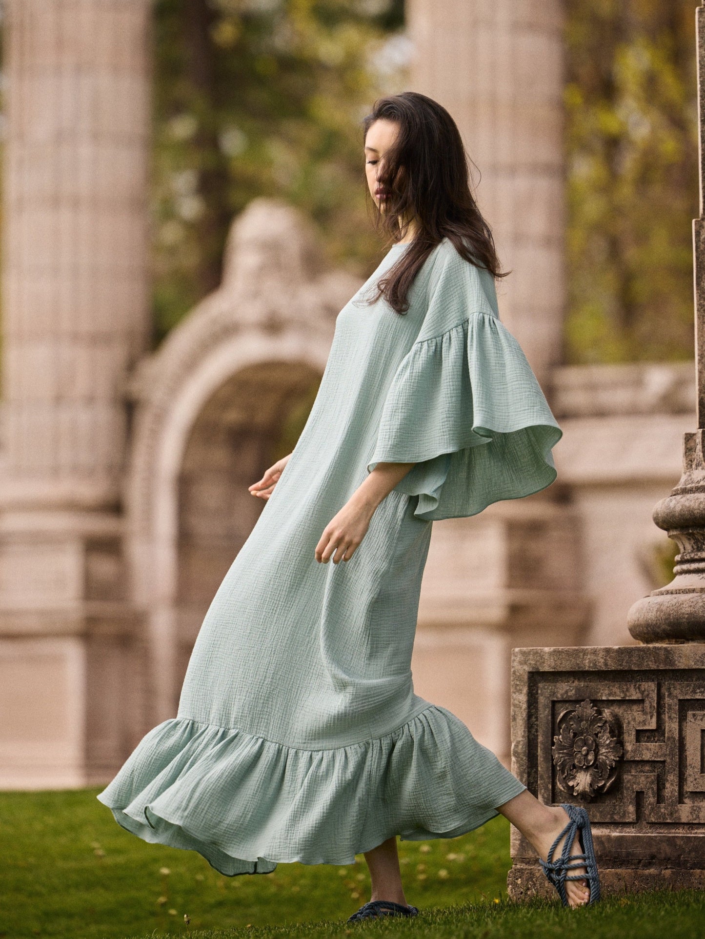 Model wearing a Liz cotton gauze caftan in mint green.